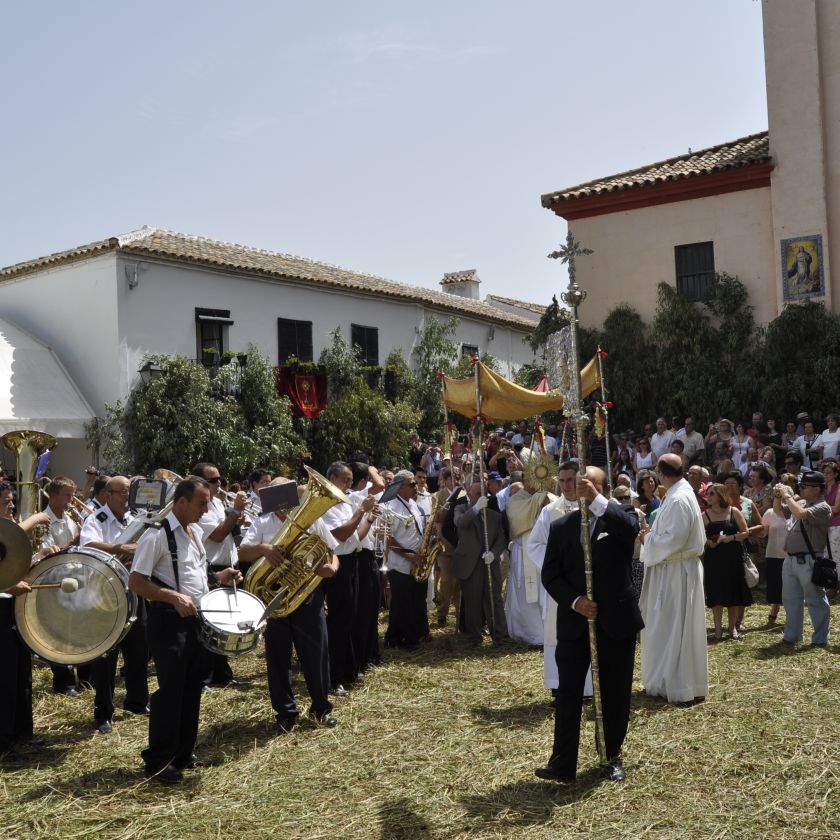 Imagen donde se muestra como la banda toca el himno a la salida del Sant&iacute;simo para su procesi&oacute;n por la villa de Zahara de la Sierra.